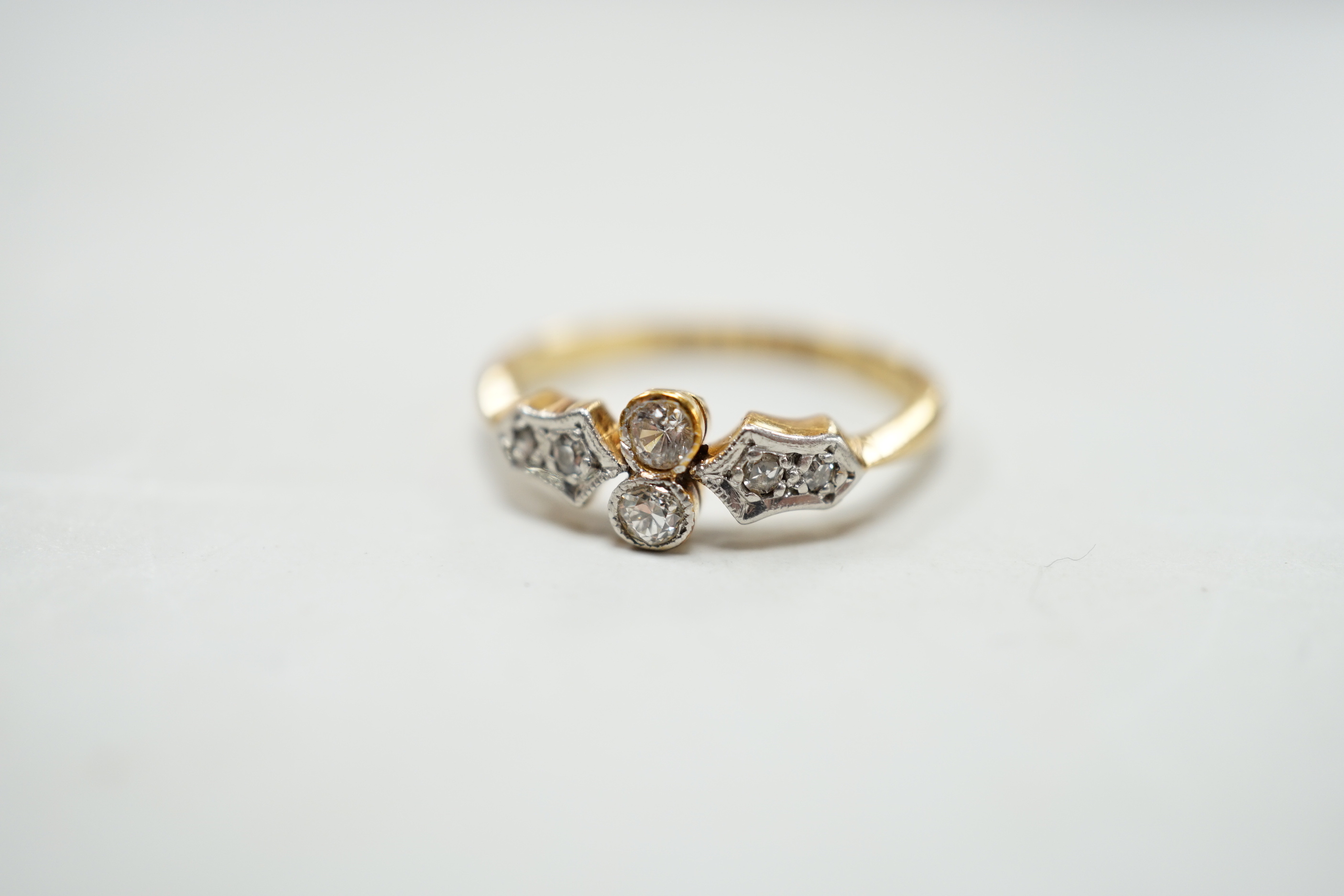 A 1920's 18ct, plat and six stone diamond chip set cluster ring, size M, gross weight 2.5 grams.